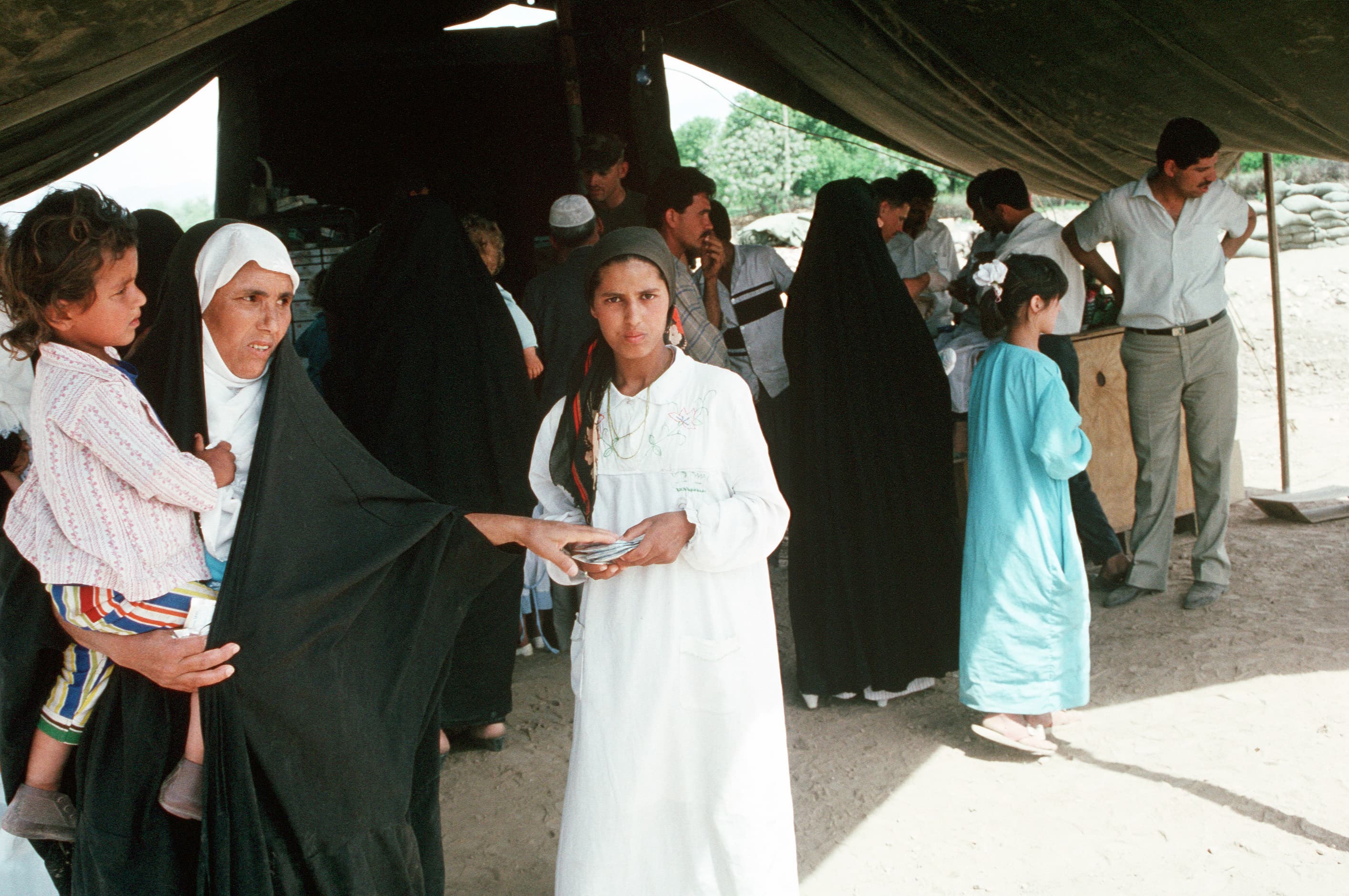 Refugees gathering at a health clinic and water purification station.